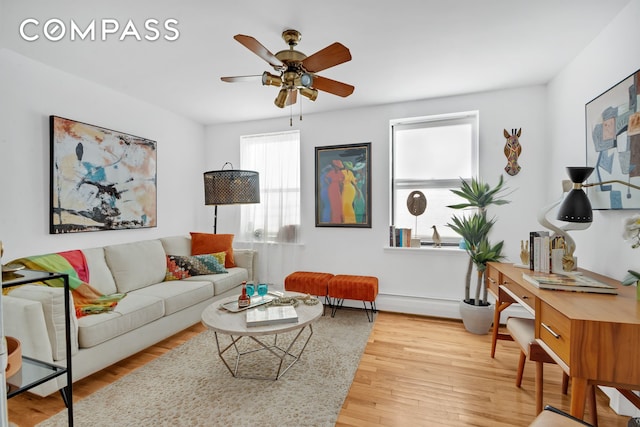 living area featuring wood finished floors and a ceiling fan