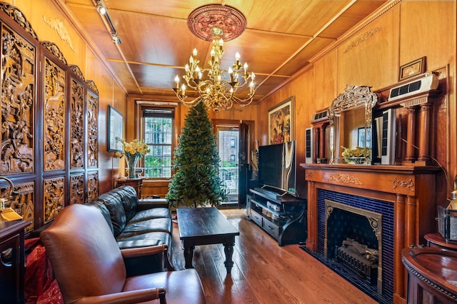 living room with wooden ceiling, wooden walls, wood finished floors, and a fireplace