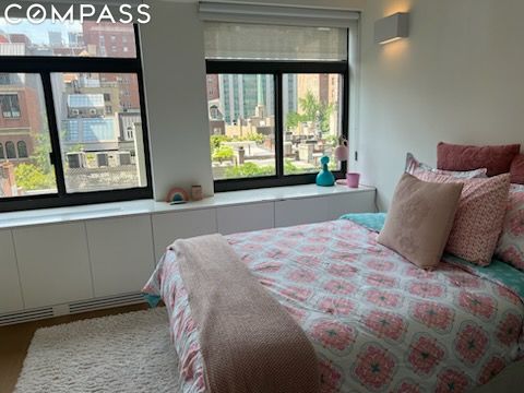 bedroom with wood-type flooring and multiple windows