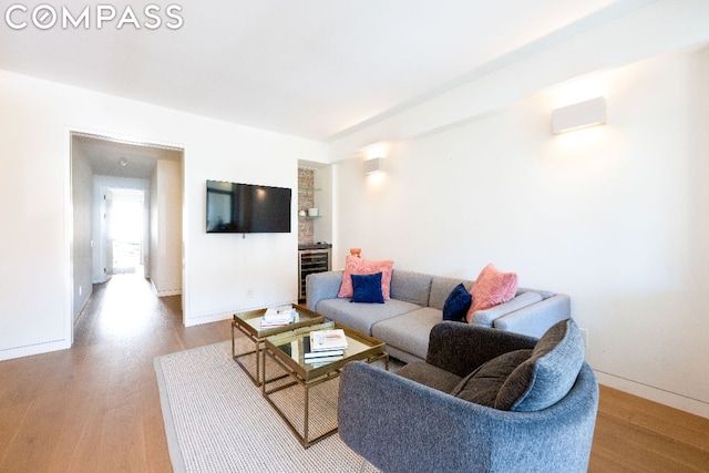 living room with wine cooler and light hardwood / wood-style flooring