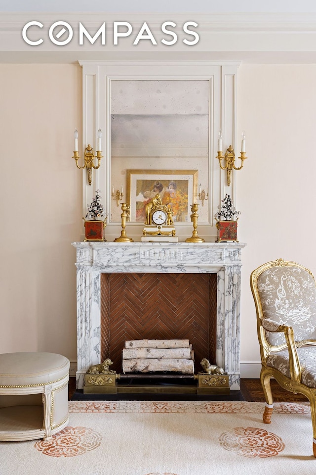 sitting room with a high end fireplace