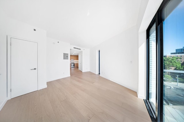 spare room with light wood finished floors and baseboards