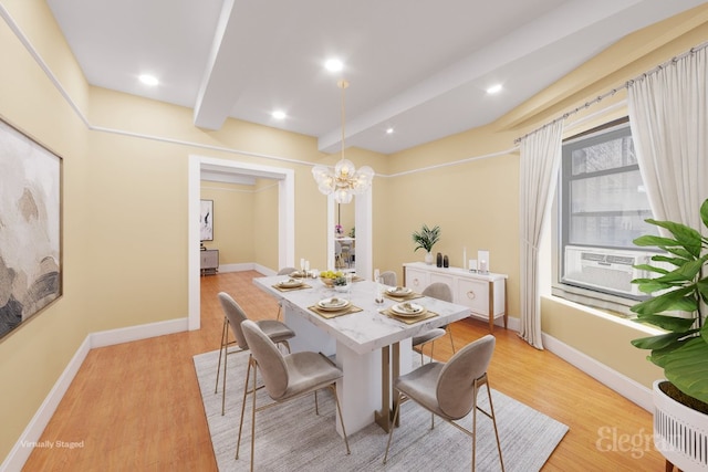 dining room with an inviting chandelier, cooling unit, beam ceiling, and light hardwood / wood-style flooring