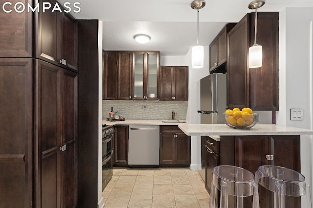 kitchen featuring dark brown cabinetry, dishwasher, and tasteful backsplash