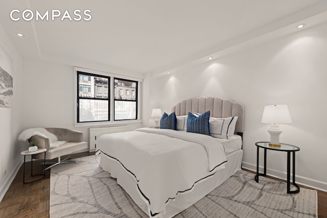 bedroom featuring baseboards, wood finished floors, and recessed lighting