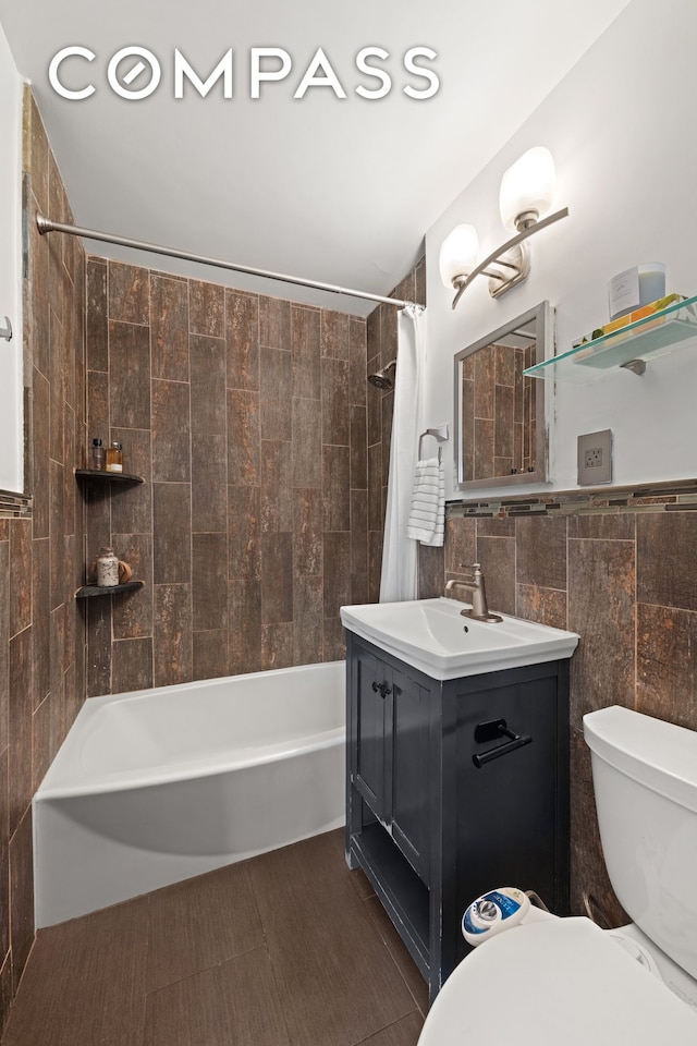 bathroom with toilet, shower / bathtub combination with curtain, tile walls, and vanity