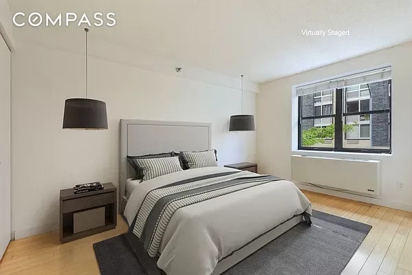 bedroom with radiator heating unit and wood finished floors