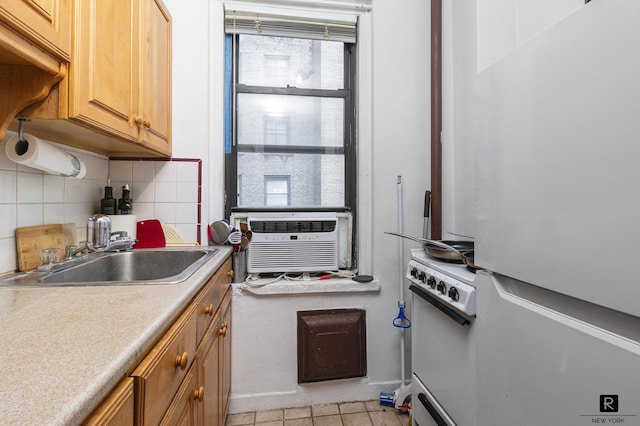 kitchen featuring white appliances, a sink, backsplash, cooling unit, and light tile patterned flooring