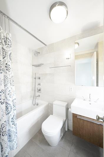 full bathroom with shower / bath combination with curtain, tile patterned floors, vanity, and toilet