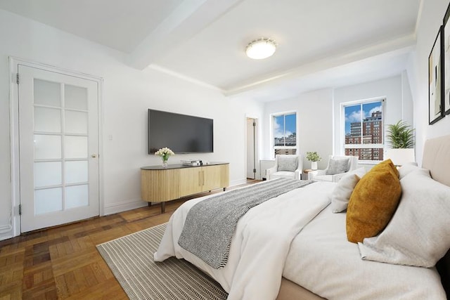 bedroom with beam ceiling and dark parquet flooring