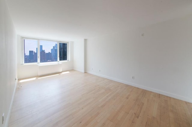 spare room with light hardwood / wood-style floors