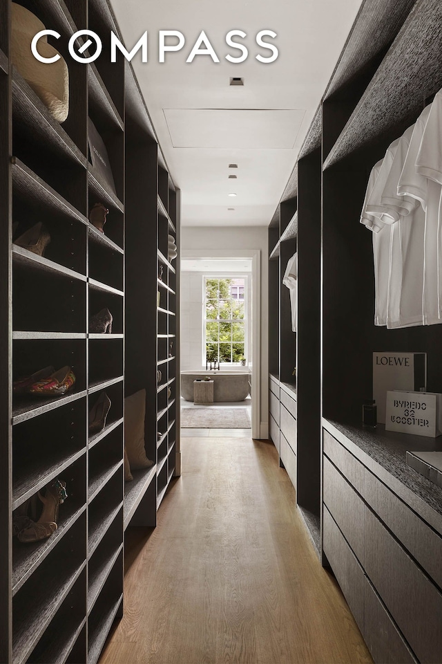 walk in closet featuring wood finished floors