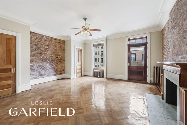 8 W 71st St, New York City, NY 10023 - unfurnished living room with radiator, brick wall, and ornamental molding