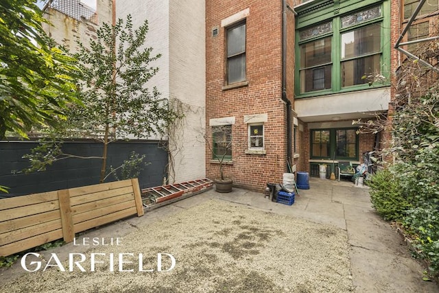 8 W 71st St, New York City, NY 10023 - rear view of property featuring a patio area and brick siding