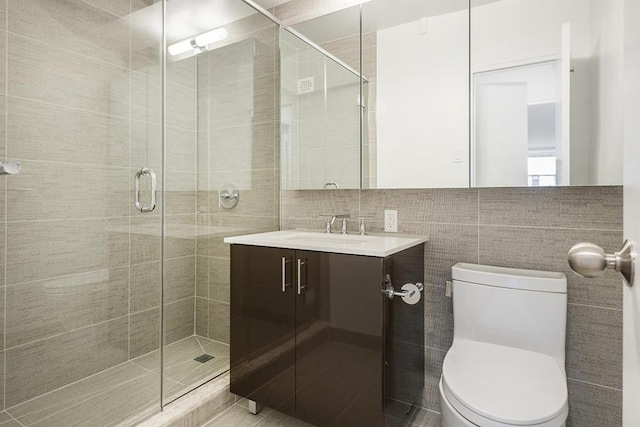 bathroom featuring tile walls, backsplash, vanity, toilet, and walk in shower