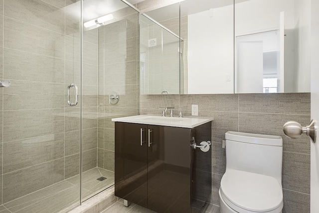 bathroom featuring tasteful backsplash, a shower stall, toilet, and vanity