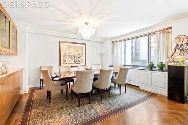 dining room with ornamental molding, parquet flooring, and an inviting chandelier