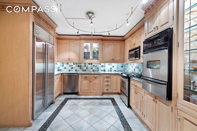 kitchen featuring a warming drawer, glass insert cabinets, tasteful backsplash, and appliances with stainless steel finishes