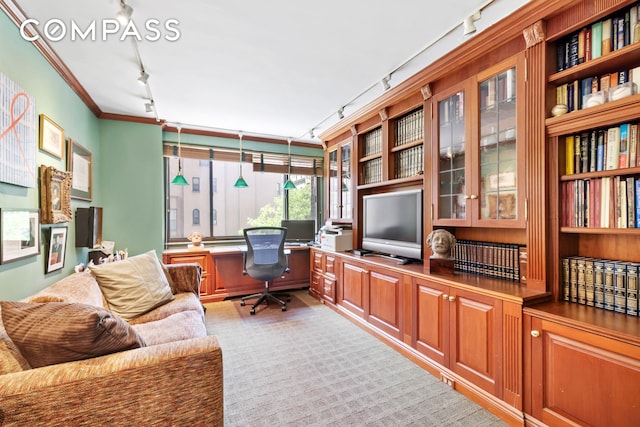 office with crown molding, rail lighting, and built in desk