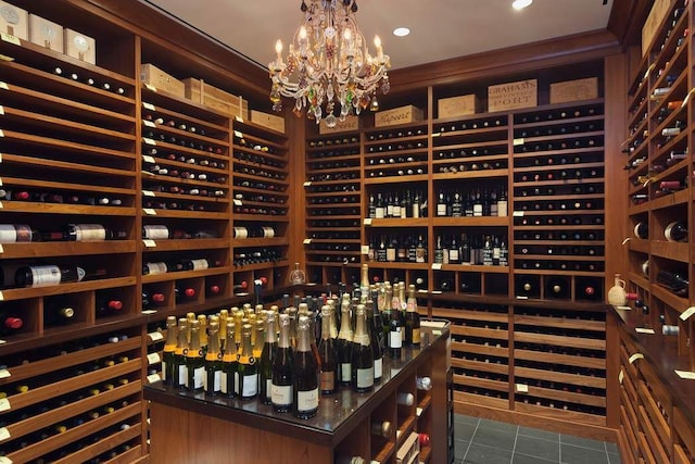 wine room with a notable chandelier and dark tile patterned floors