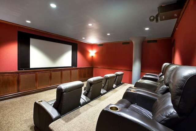 carpeted home theater room featuring ornamental molding and ornate columns