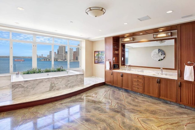 bathroom with a water view, ornamental molding, vanity, and a bath