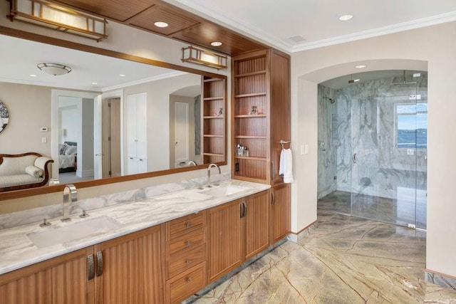 bathroom featuring vanity, crown molding, and walk in shower