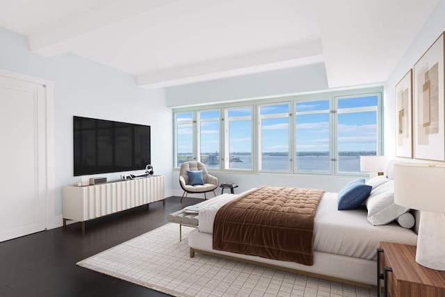 bedroom featuring beam ceiling and light hardwood / wood-style floors