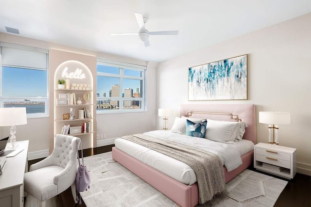 bedroom with multiple windows, ceiling fan, and light hardwood / wood-style flooring