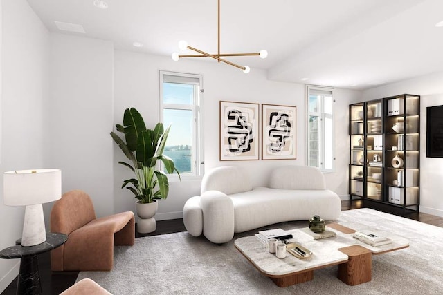 living room with hardwood / wood-style flooring, a healthy amount of sunlight, and an inviting chandelier