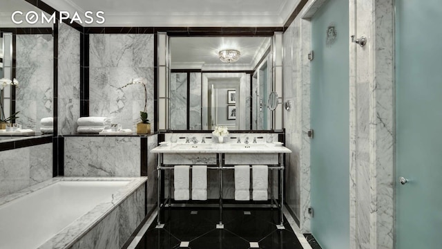 full bath with crown molding, double vanity, a sink, a tub with marble appearance, and tile patterned floors