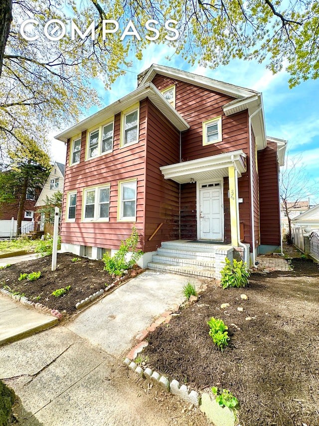 view of front of house featuring a chimney