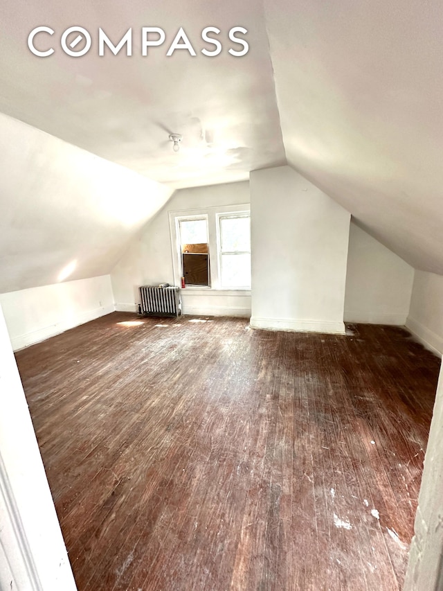 bonus room with radiator, hardwood / wood-style flooring, and lofted ceiling