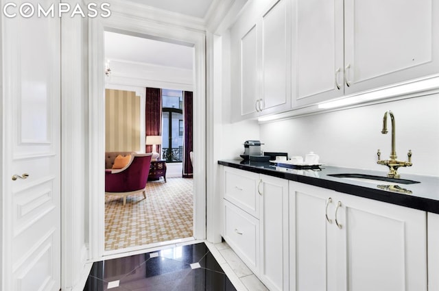 kitchen featuring white cabinetry and sink