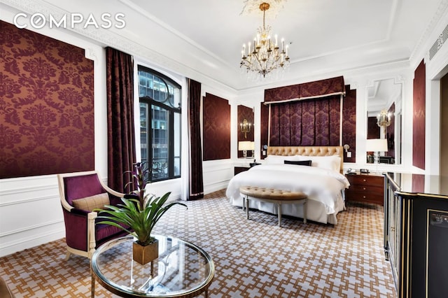 bedroom featuring a wainscoted wall, a notable chandelier, crown molding, and a decorative wall