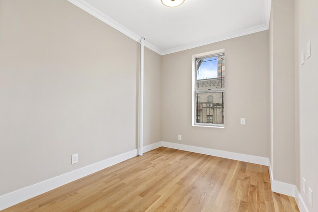 spare room with crown molding and light hardwood / wood-style floors