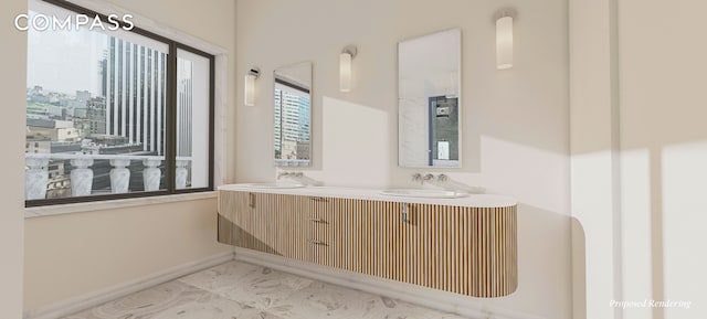 full bathroom featuring double vanity, baseboards, and a sink