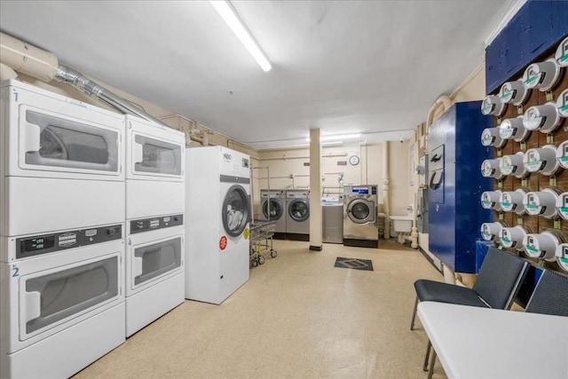 laundry area with washing machine and dryer and stacked washer and clothes dryer