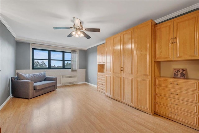 living area featuring ceiling fan, ornamental molding, light hardwood / wood-style flooring, and radiator heating unit