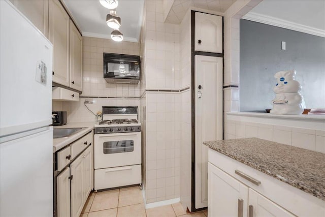 kitchen featuring ornamental molding, white appliances, light stone countertops, and light tile patterned floors