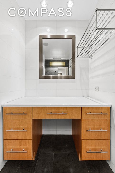 bathroom with tile walls, vanity, and tile patterned floors