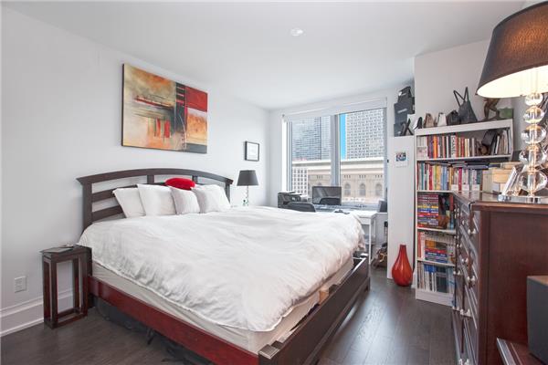 bedroom with dark hardwood / wood-style flooring