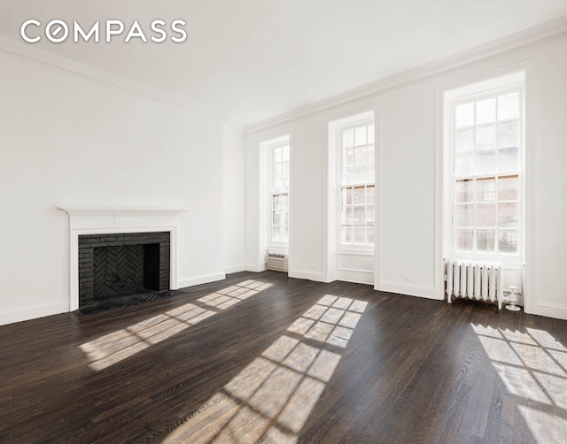 unfurnished living room with wood finished floors, radiator, and ornamental molding