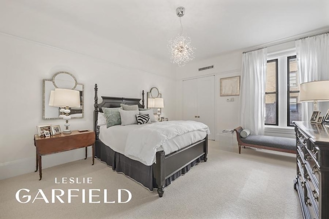 bedroom with carpet flooring and an inviting chandelier