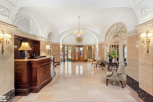 welcome area with french doors and a chandelier