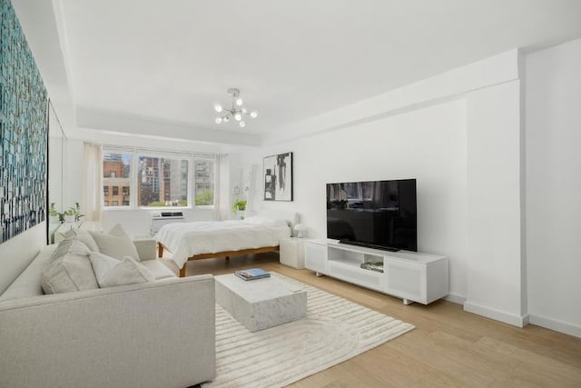 bedroom featuring a notable chandelier and light hardwood / wood-style floors