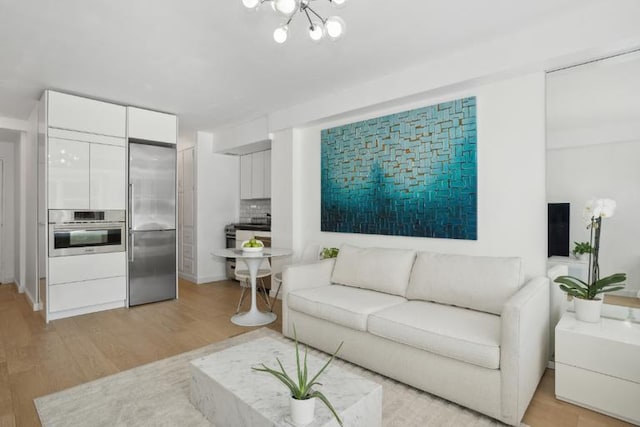 living room featuring a chandelier and light hardwood / wood-style floors