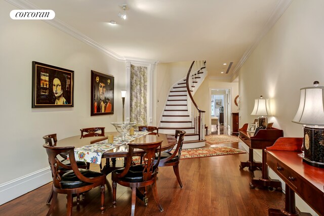 dining area with hardwood / wood-style flooring and ornamental molding