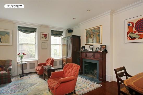 living area with dark hardwood / wood-style flooring and ornamental molding