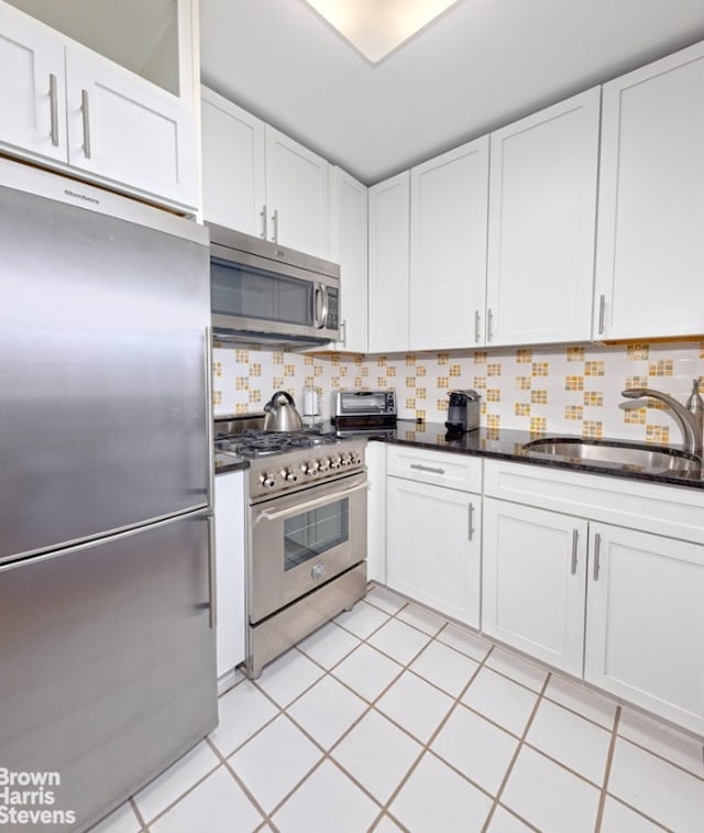 kitchen featuring white cabinetry, sink, backsplash, and high quality appliances